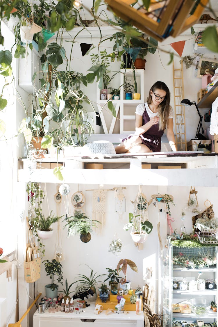 Young Woman Inside Modern Stylish Room With Two Tier Layout And Floral Design