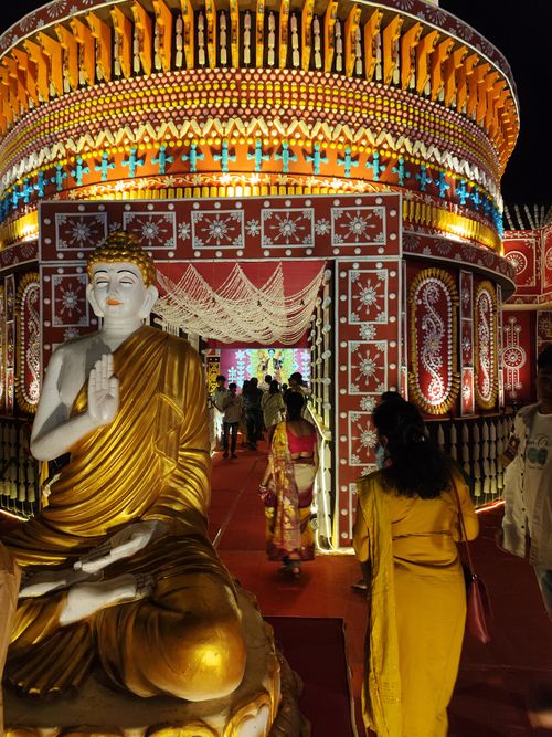 Free Illuminated temple with Buddha statue at night festival, vibrant colors. Stock Photo