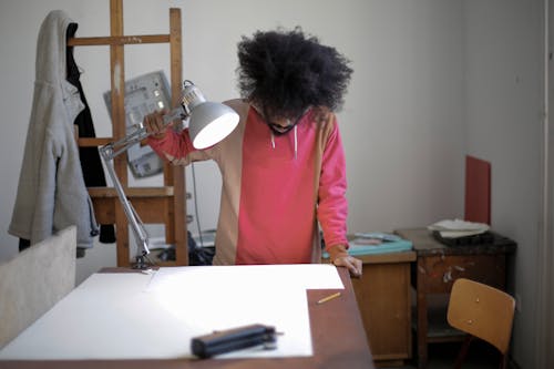 Man Fixing the Lighting on His Table