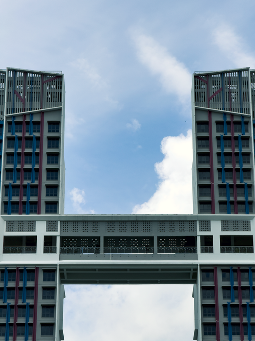 Free Dramatic view of a modern high-rise building against a cloudy sky. Stock Photo