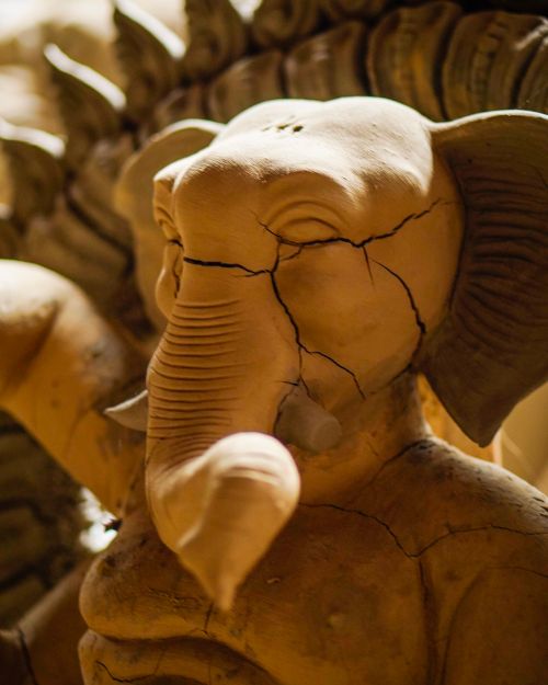 Free A beautifully detailed clay elephant sculpture showcasing art and craftsmanship in warm ambient lighting. Stock Photo
