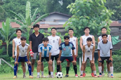 Free A local football team poses outdoors for a group photo in Myawadi, Myanmar. Stock Photo