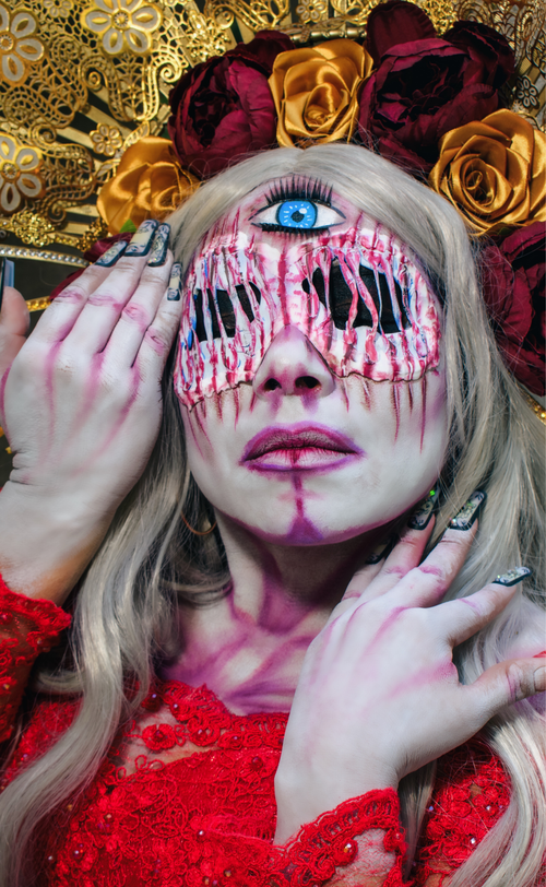 Free A striking and surreal portrait featuring a person in elaborate makeup and costume with floral headpiece and dramatic eye details. Stock Photo