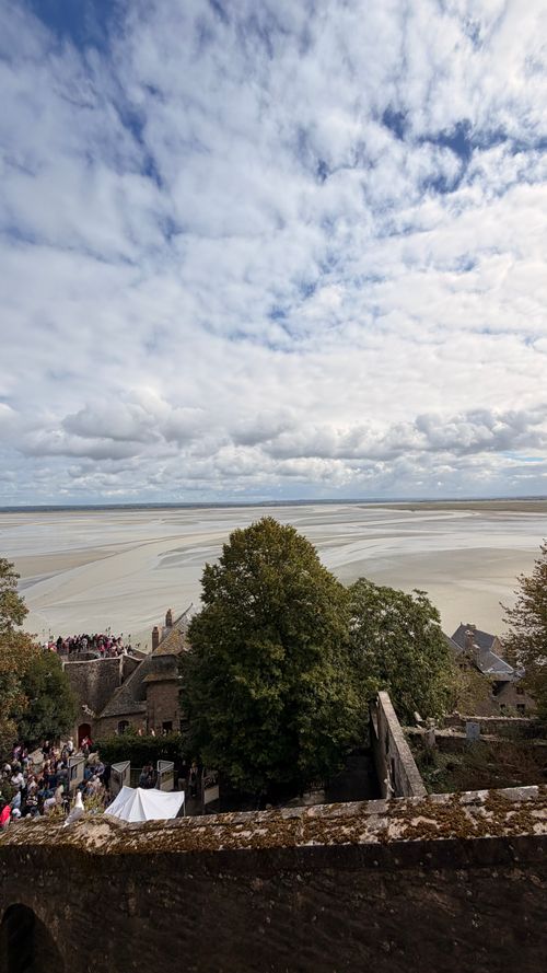 Free Explore the stunning aerial view of Le Mont-Saint-Michel with expansive skies and serene sands. Stock Photo