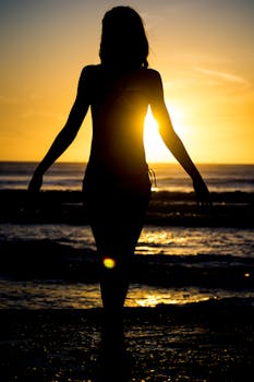 Woman Walking at the Beach during Sunset