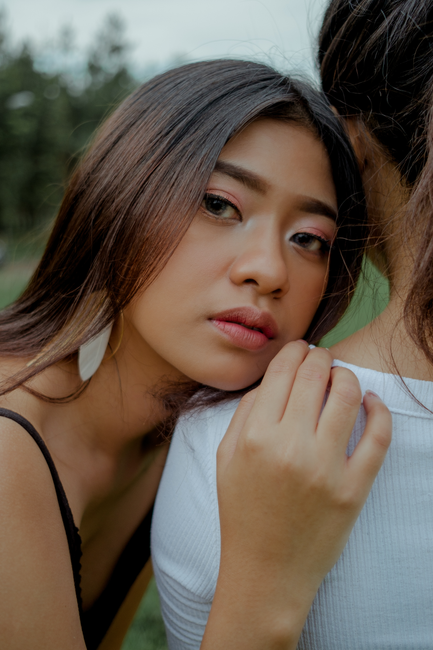 Stunning portrait of a young Asian woman with natural makeup, leaning towards the camera.