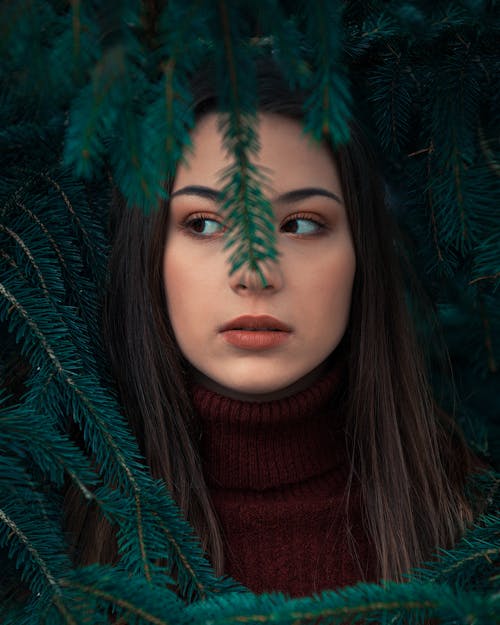 Beautiful Woman Behind Green Leaves