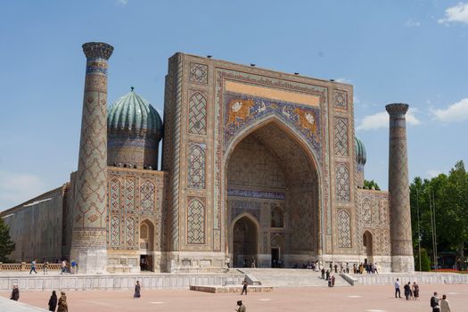 Breathtaking view of the Registan Square, featuring the ornate facade of the Sher-Dor Madrasah in Samarkand, Uzbekistan.