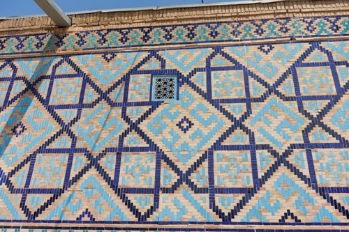 Free Beautiful geometric tile patterns on a historic building wall in Samarkand, Uzbekistan. Stock Photo