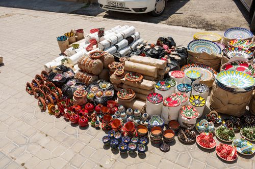 Free Vibrant handmade ceramics displayed outdoors in Samarkand's bustling market. Stock Photo