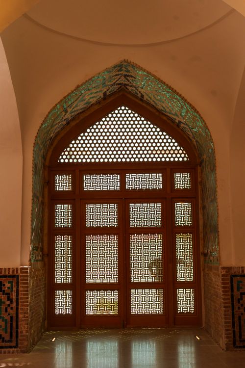 Free Traditional wooden lattice door design inside a historic building in Samarkand, Uzbekistan. Stock Photo