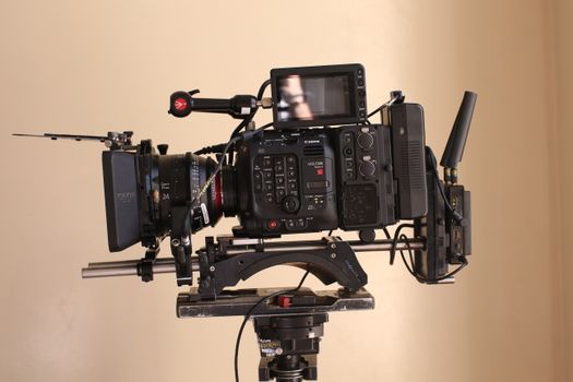 Canon EOS-1D C video setup with monitor on tripod, ideal for filmmakers.