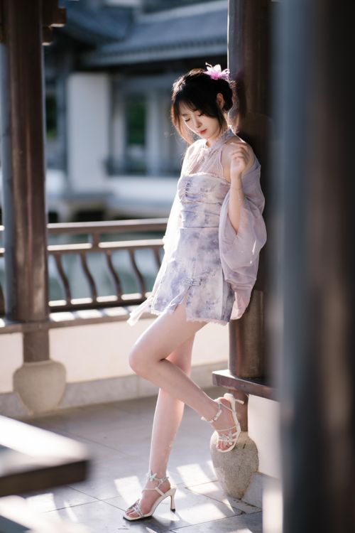 Free A serene moment featuring a woman in elegant traditional Asian dress outdoors. Stock Photo