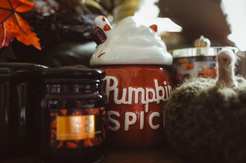 Free Warm autumn decor arrangement featuring pumpkin spice and cozy candles. Stock Photo
