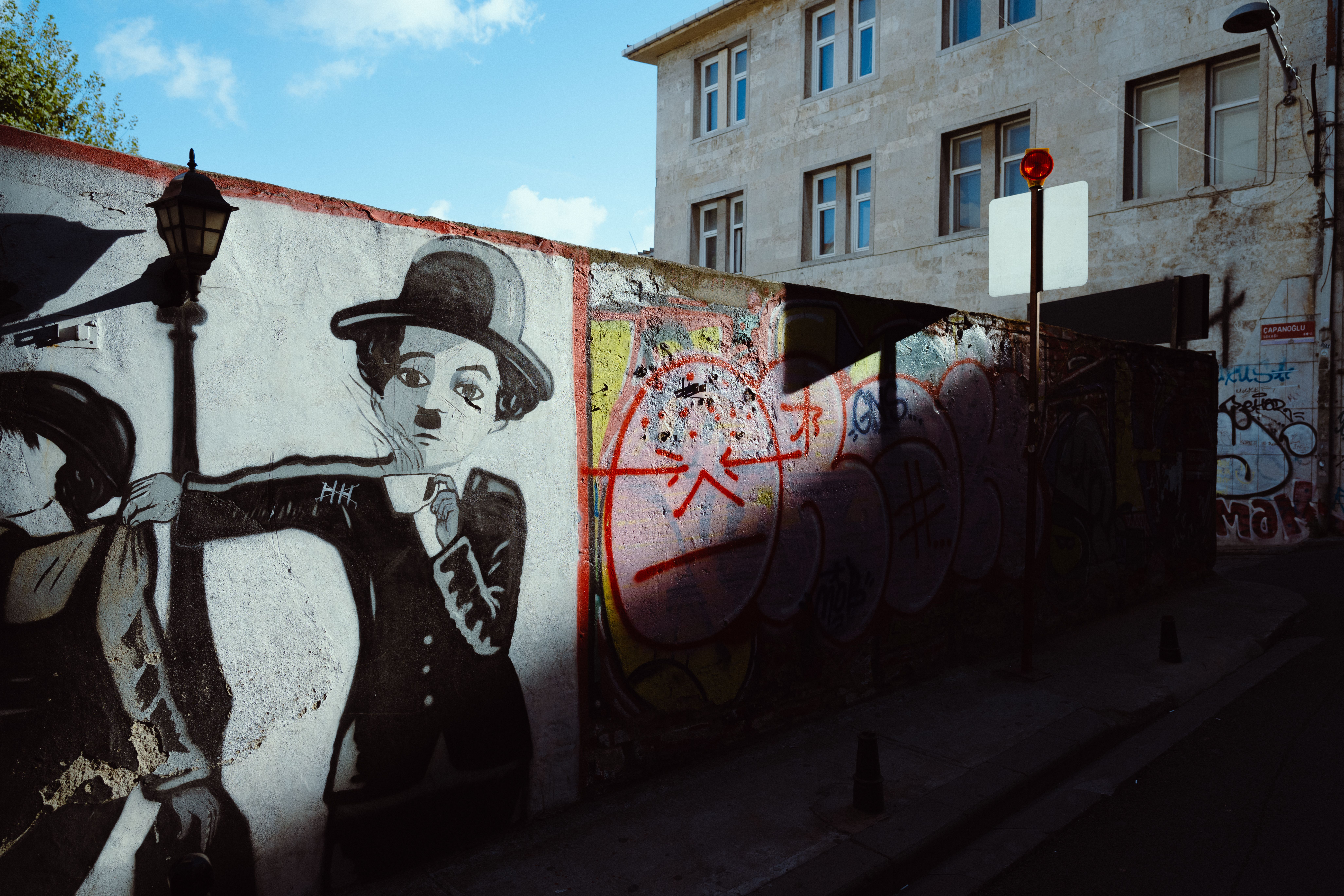 Street art featuring iconic character on a sunlit wall in Istanbul's Cihangir district.