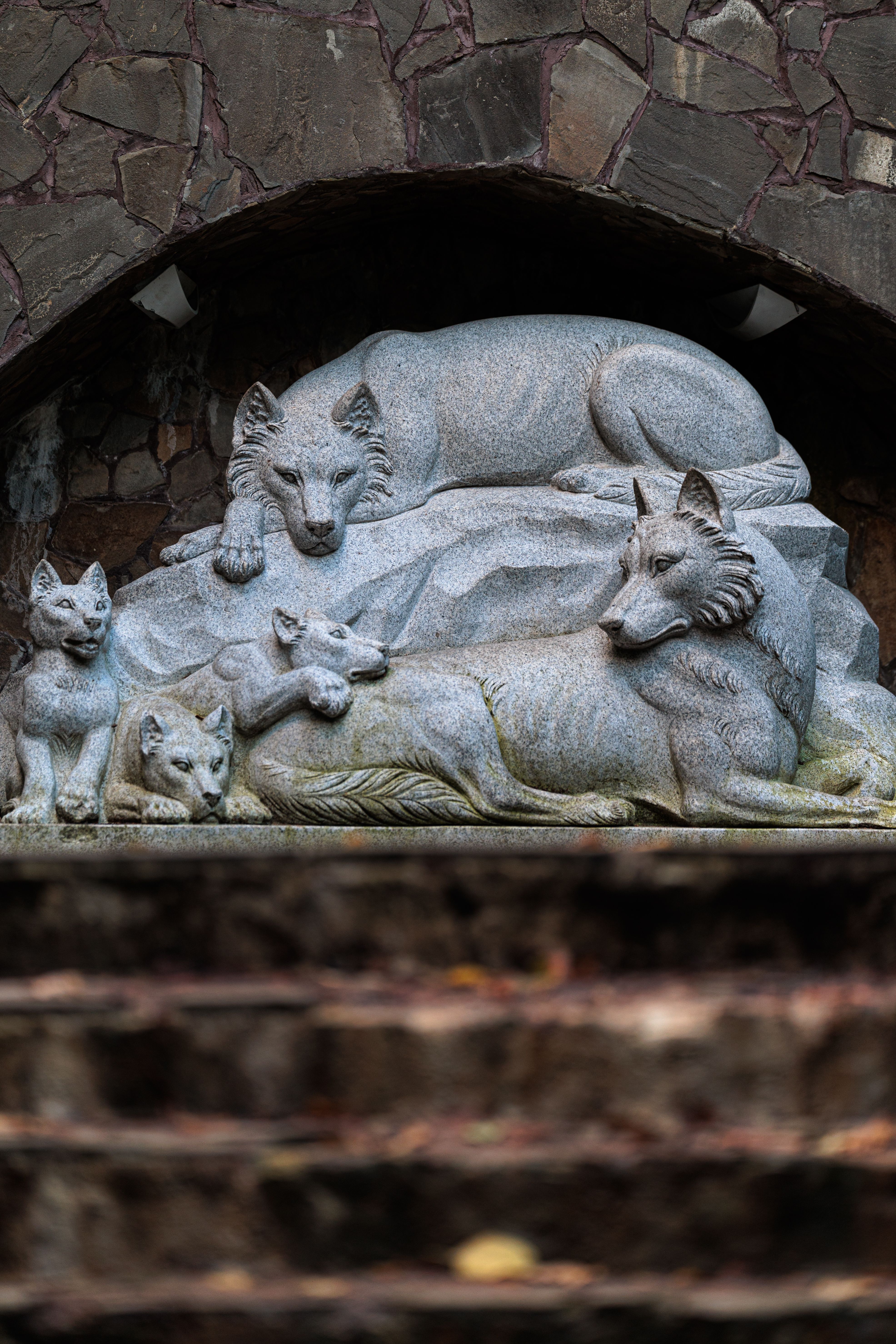 Intricate stone wolf sculpture in Kaliningrad, showcasing detailed artistry and natural themes.