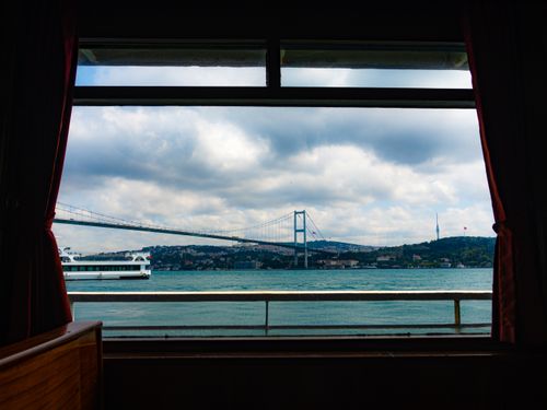 Free View of the Bosphorus Bridge from inside a boat, capturing a unique perspective of Istanbul's iconic landscape. Stock Photo