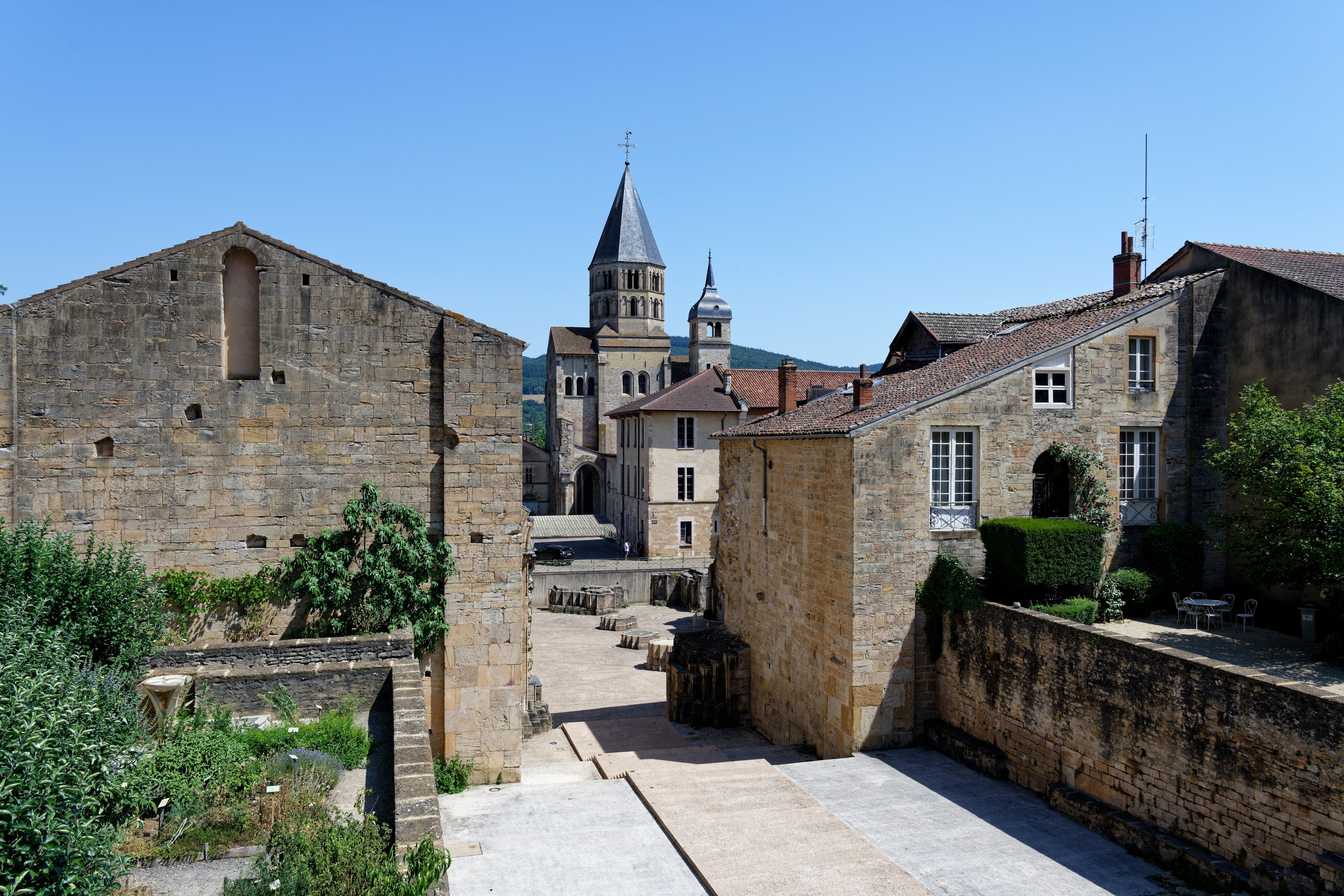 View of the historical abbey in Cluny, France showcasing medieval architecture under a clear sky.