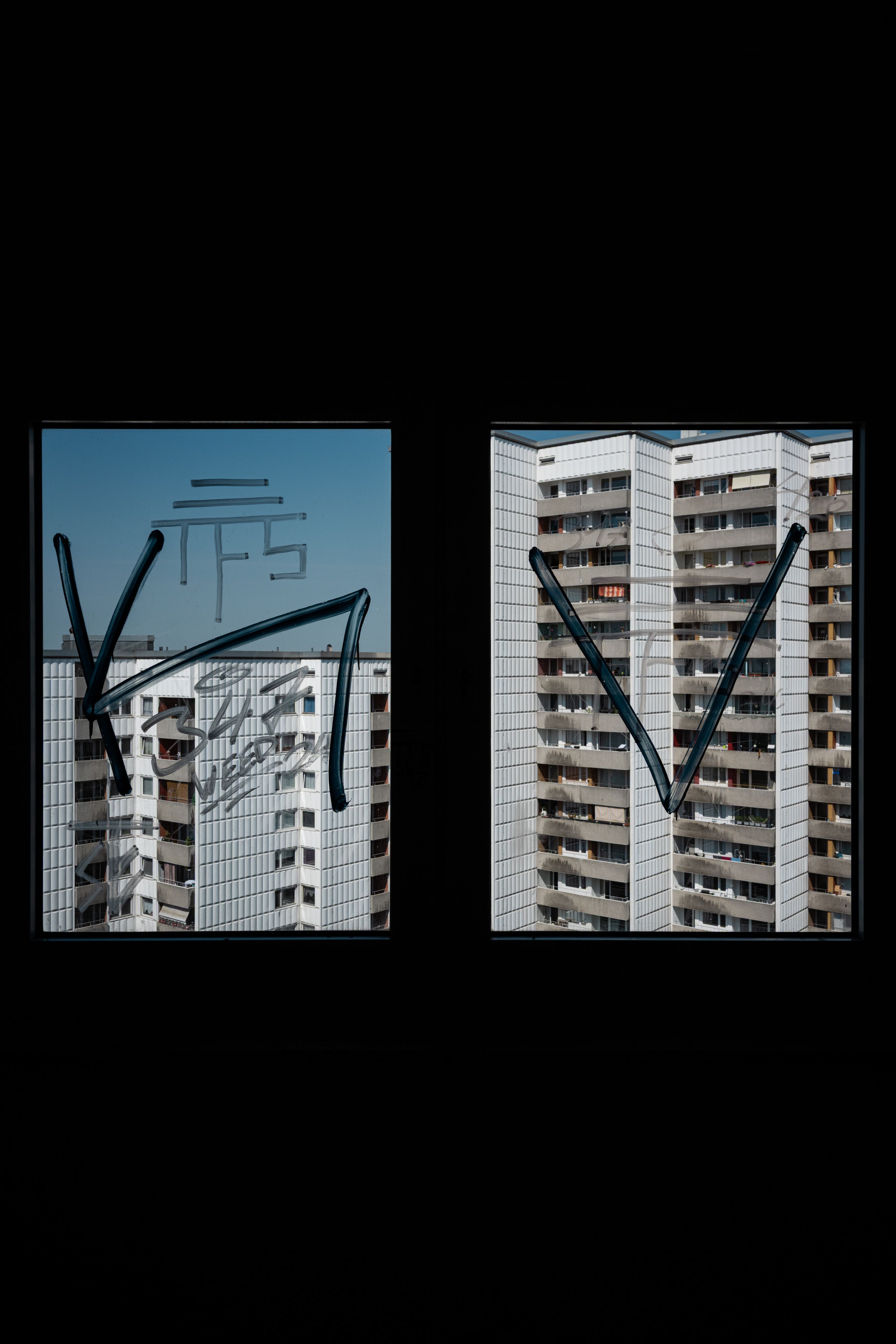 Captivating view of Berlin's Plattenbau through a window, showcasing unique brutalist architecture.