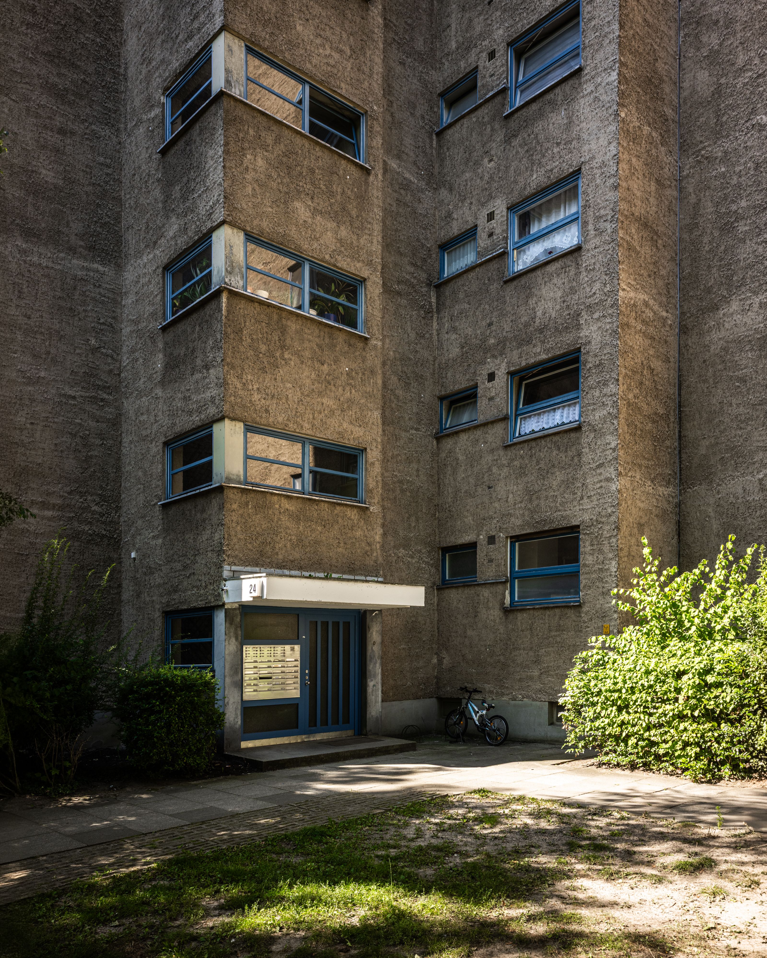 Low-angle view of a classic Brutalist building facade in Berlin, showcasing geometric architecture.