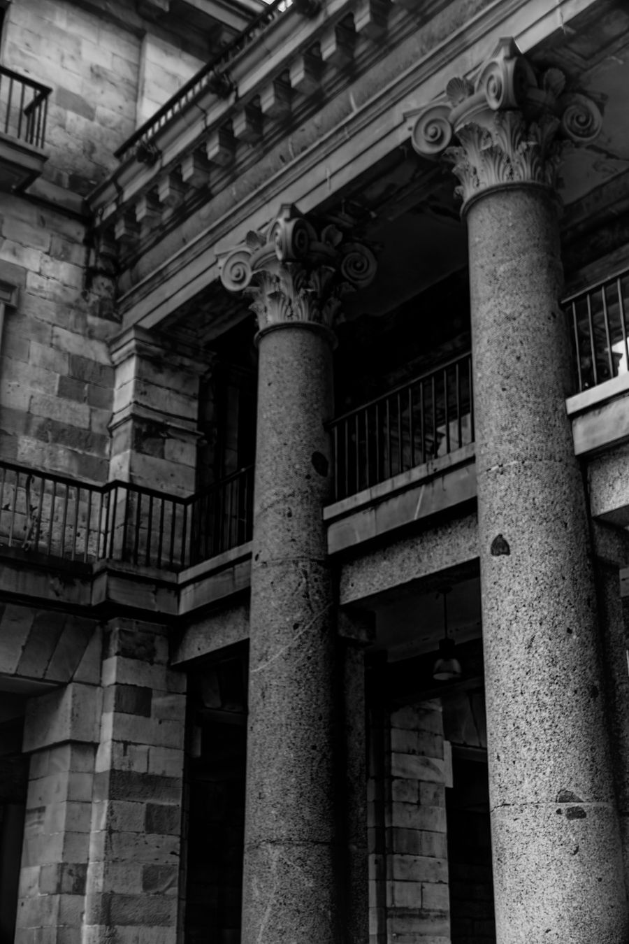 Towering stone columns viewed from below in dramatic black and white