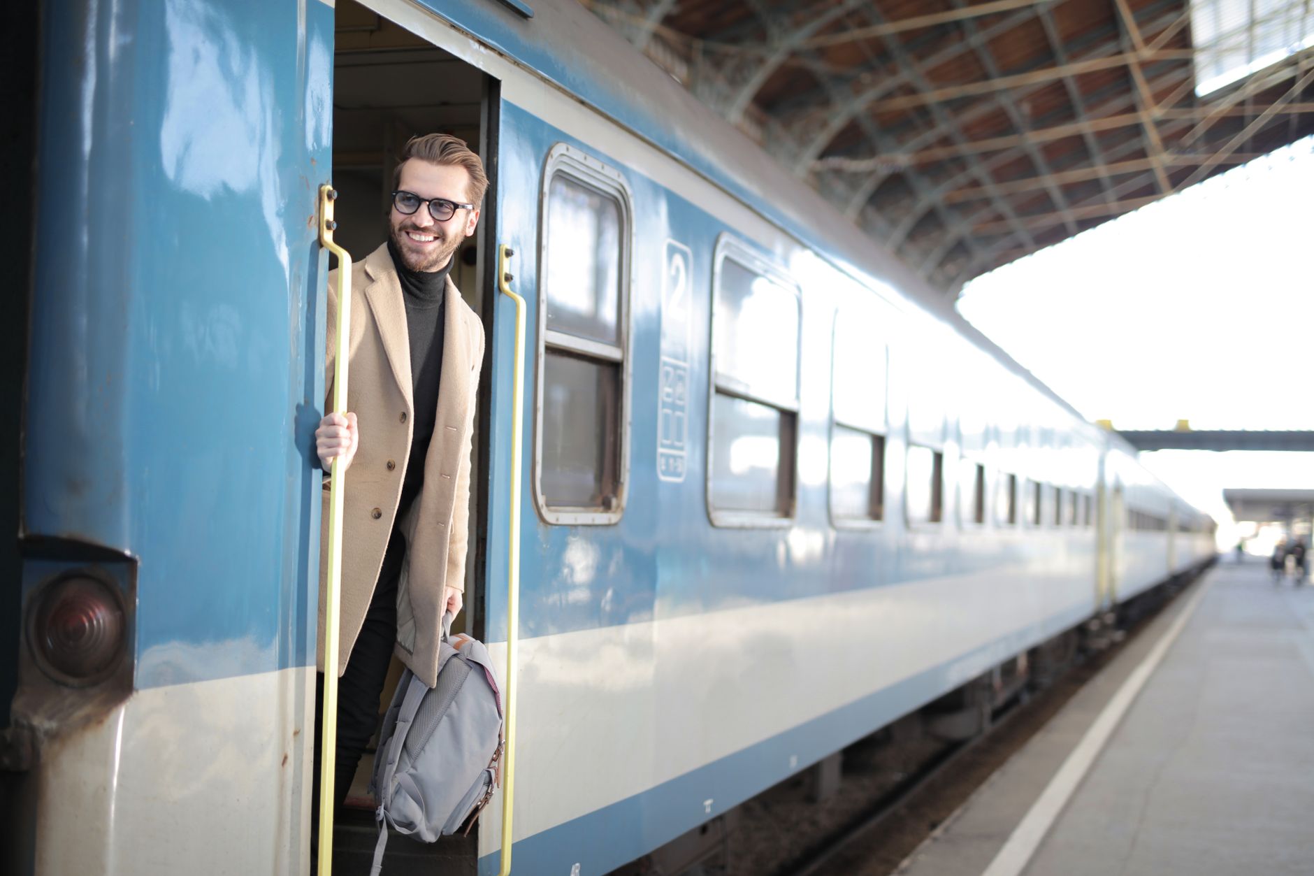 Man Smiling Going Out The Train Free Stock Photo man-smiling-going-out-the-train-free-stock-photo