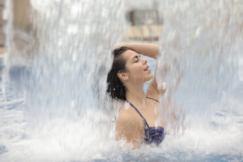 Woman in Blue Bikini Top in Water