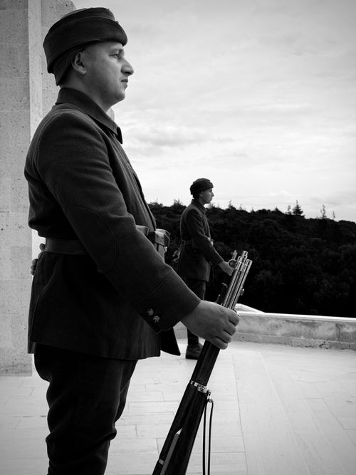 Free Black and white photo of soldiers in historic uniforms standing guard at a memorial. Stock Photo