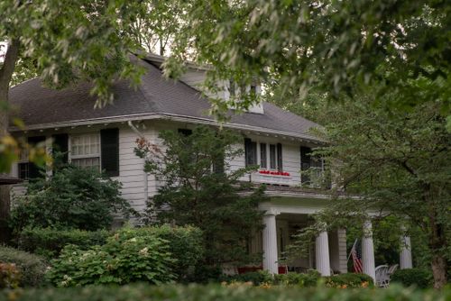 Free Charming colonial house surrounded by lush greenery in Somerville, Massachusetts. Stock Photo