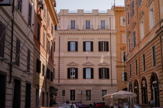 Elegant Roman architecture with a vibrant street scene captured in daylight.