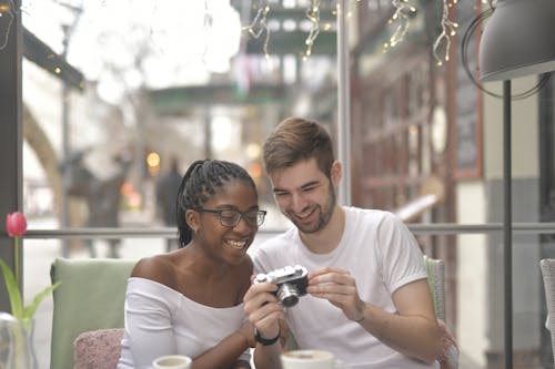 Couple Holding Camera Reminiscing Memories
