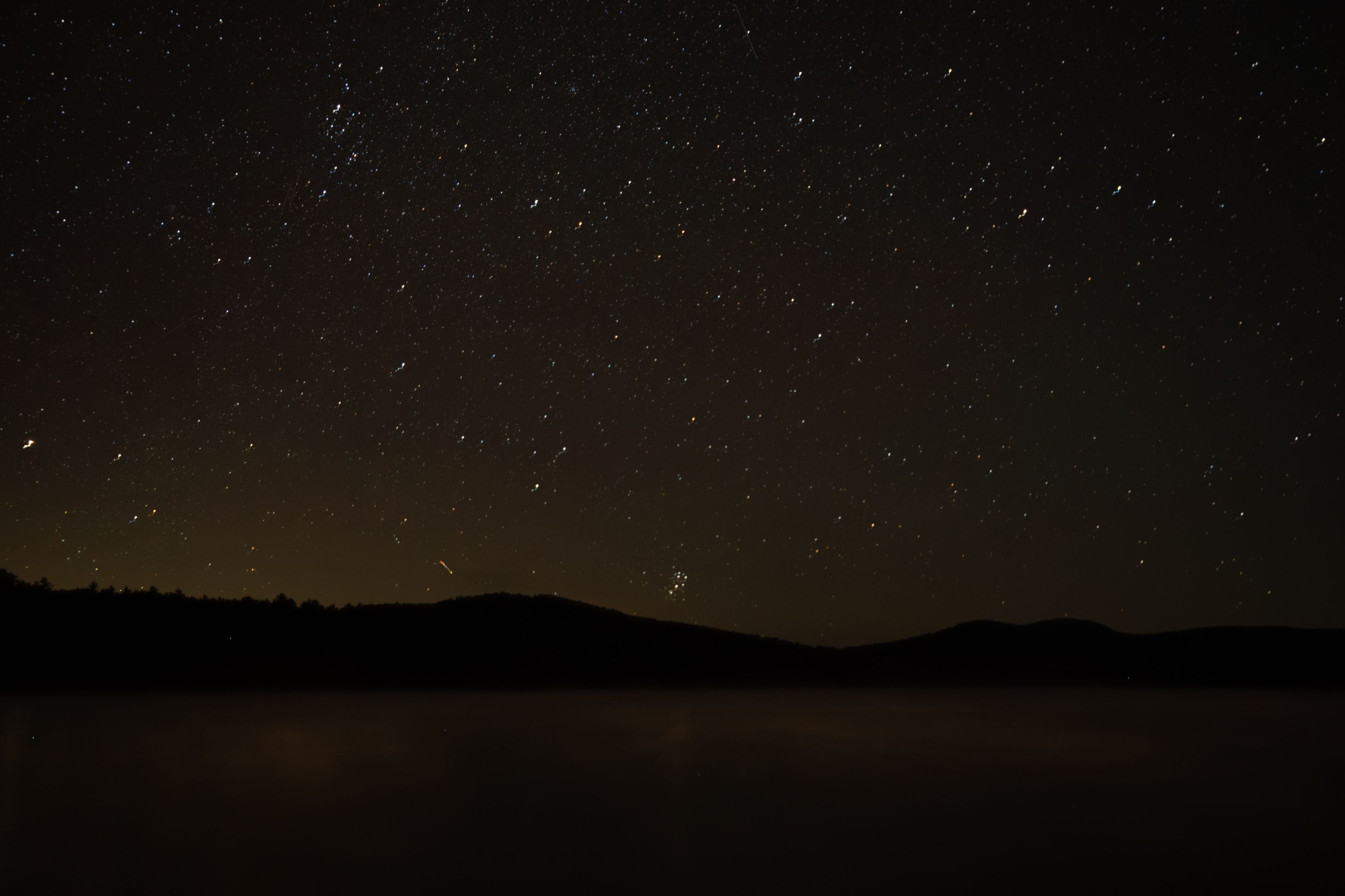 Serene night sky filled with stars above a silhouetted landscape, perfect for celestial themes.
