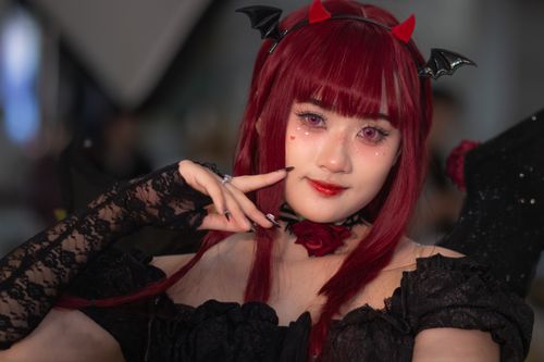 Free Captivating portrait of a young woman in Gothic cosplay with red hair and intricate accessories. Stock Photo