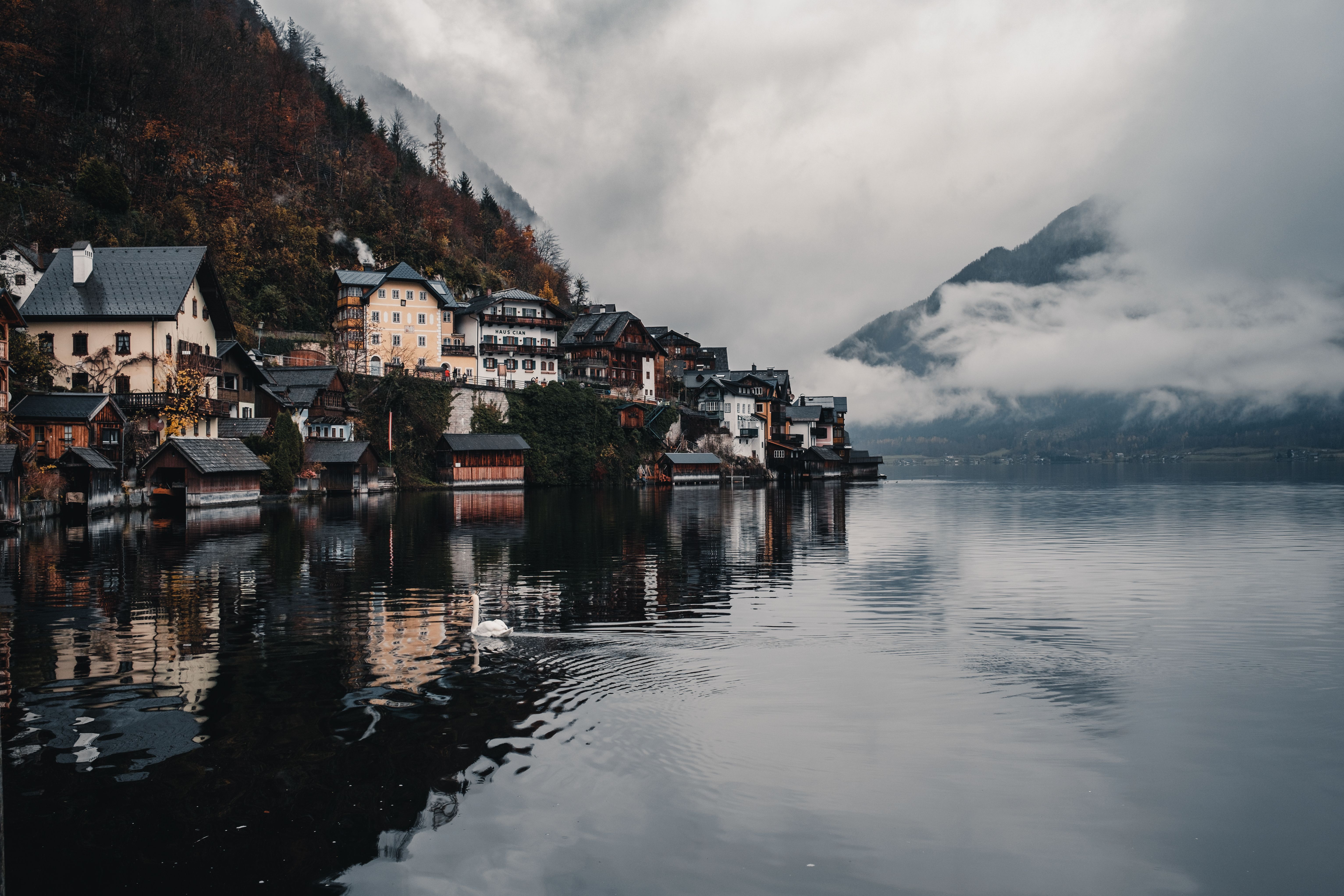 Picturesque Hallstatt village with misty mountains and calm waters creating a serene atmosphere.