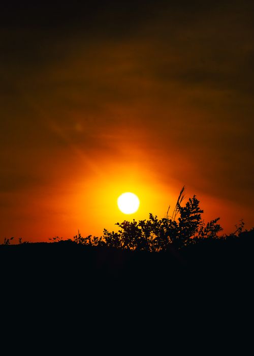 Free Beautiful sunset casting a warm glow over Zaria, Nigeria's natural horizon. Stock Photo