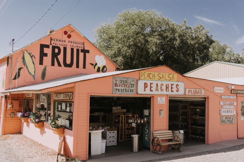 Colorful fruit stand in Palisade, Colorado, selling local produce and peaches.