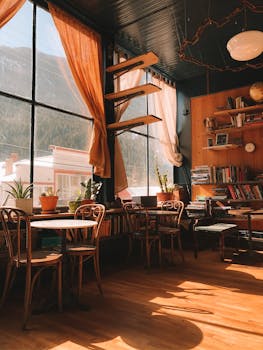 Warm, sunlit café in Silver Plume, Colorado with wooden furniture and bookshelves.