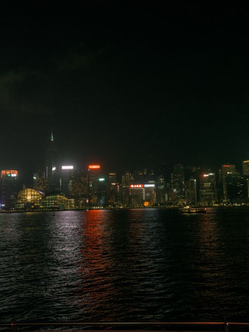 Free Captivating view of Hong Kong's illuminated skyline reflecting over Victoria Harbour at night. Stock Photo