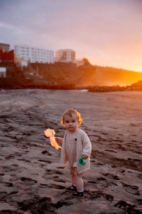 Little Girl Playing On the Sand