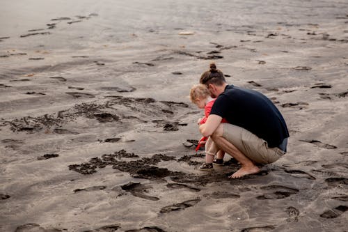 Free Father and Child Playing on Sand Stock Photo