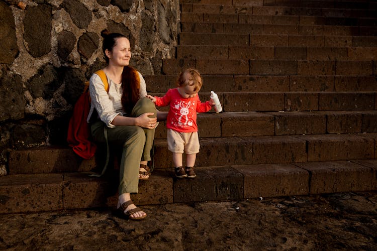 Mother And Child Sitting On The Stairs