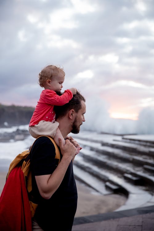 Free Father Carrying His Child on His Shoulder Stock Photo