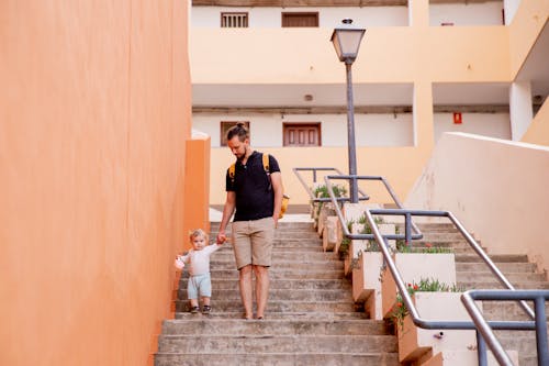 Free Man and Child Walking Down on Stairs Stock Photo