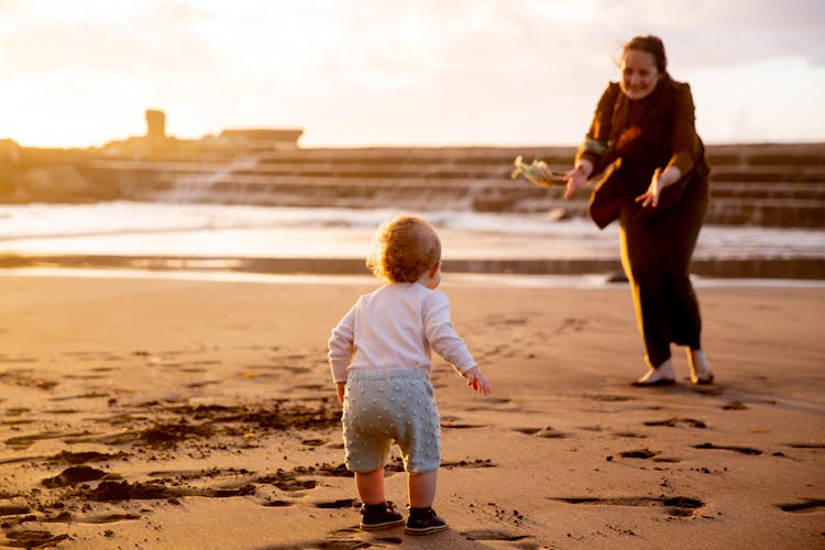 Mother And Child Playing On The Shore