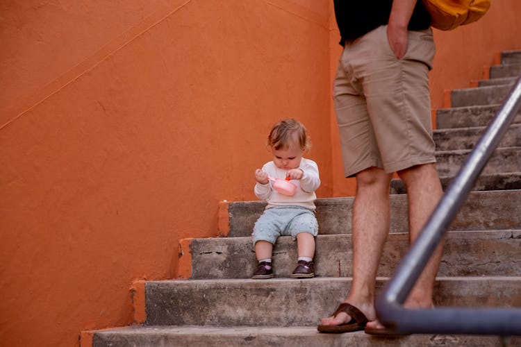 Little Kid Sitting On The Stairs