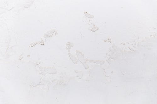 Free White shabby concrete wall with cracked stucco Stock Photo