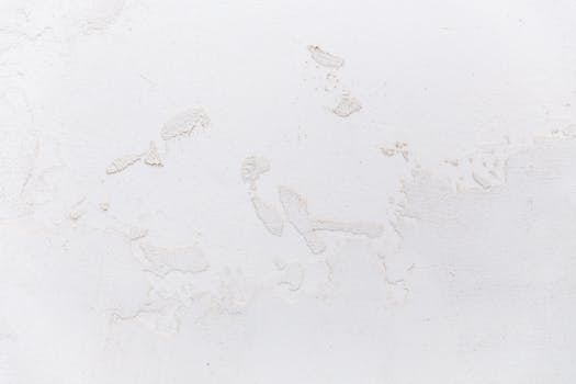 Close-up of a textured white stucco wall, ideal for design and decor projects.