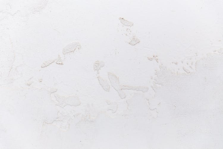 White Shabby Concrete Wall With Cracked Stucco