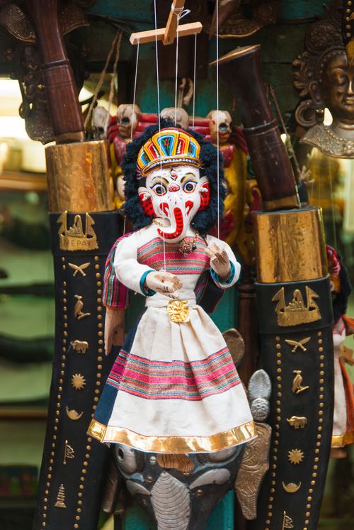 Free Colorful Nepali puppet with cultural attire, displayed in a market setting. Stock Photo