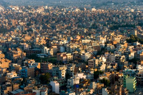 Free Aerial view of Kathmandu's dense urban landscape showcasing numerous buildings at sunset. Stock Photo